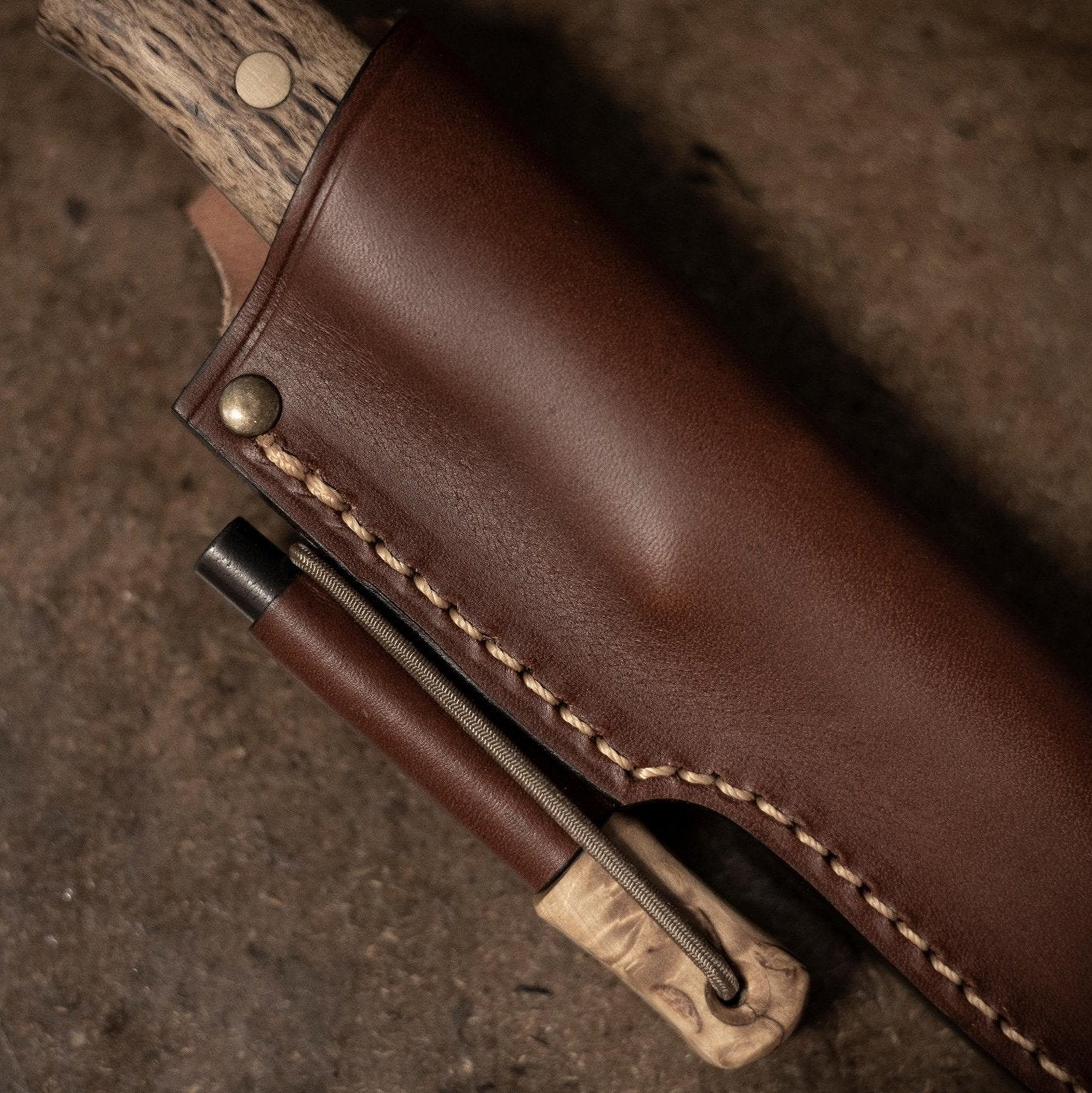 Close up of the Casström Lars Fält knife with firesteel, knife in sheath.