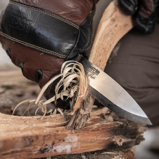 Close-up of feathersticks being carved for firelighting using the Casström Lars Fält Bushcraft Knife.
