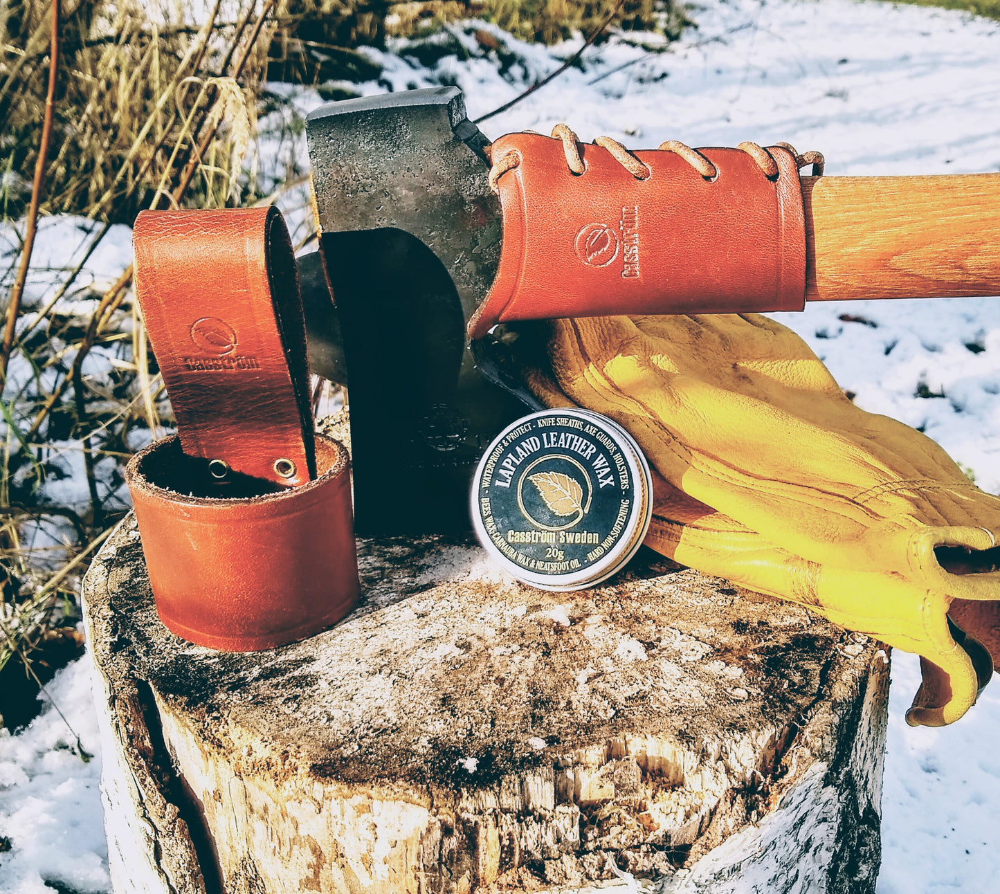 Casström Leather Axe Overstrike Guard fitted to an axe, with the Casström Axe Loop And Lapland Leather Wax in the photo