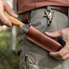 No.8 SFK Scandi Grind with curly birch handle being sheathed on the belt.