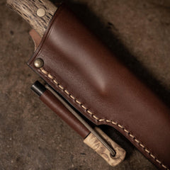Close up of the Casström Lars Fält knife with firesteel, knife in sheath.