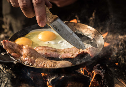 Preparing food over a campfire using the Casström No.10 bushcraft knife