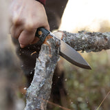 Casström No.10 Swedish Forest Knife with green Micarta handle slicing cleanly through a small branch during bushcraft use.