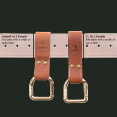 Two Casström leather danglers - the standard and XL versions - with brass D-Rings on a white background, labeled for different belt widths.