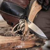 Close-up of feathersticks being carved for firelighting using the Casström Lars Fält Bushcraft Knife.