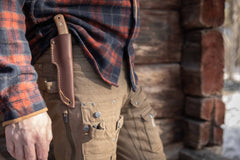 Casström No.10 Swedish Forest Knife with Canvas Micarta handle worn on a leather belt during outdoor bushcraft activity.