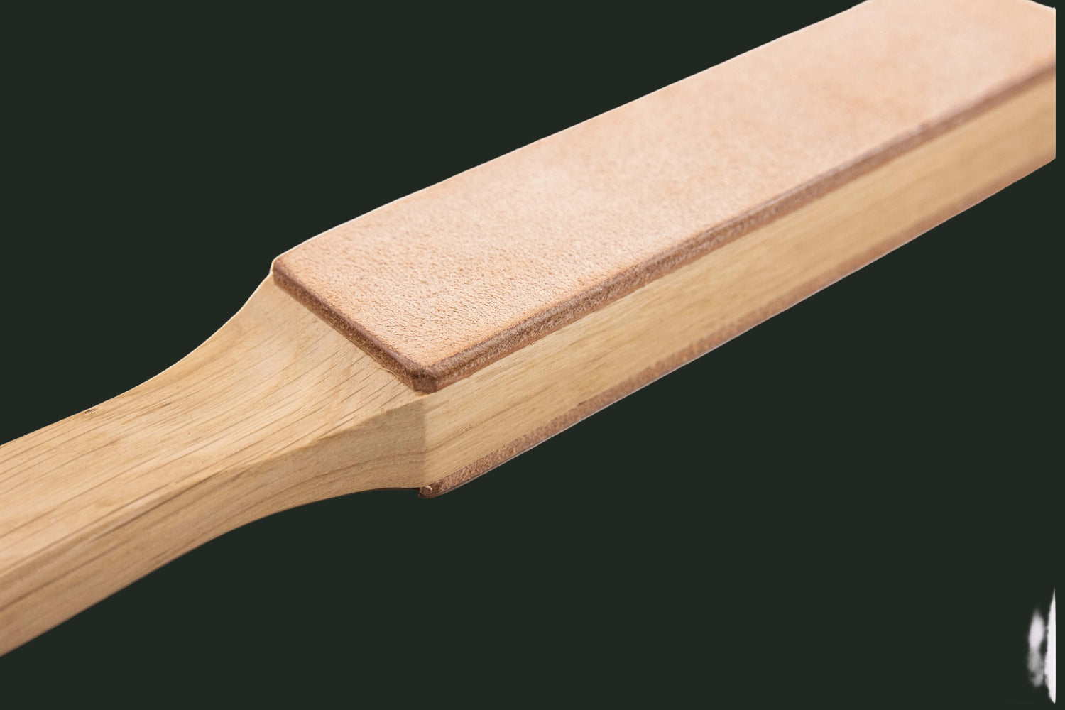 Casström Paddle Strop displayed in a studio product photograph showing dual-surface leather construction for knife maintenance.