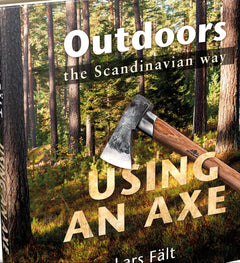 Book titled 'Outdoors the Scandinavian way: Using an Axe' by Lars Fält with a forest background on the cover.