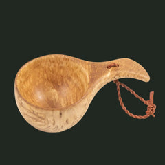 Scandinavian kuksa cup showing interior and carved wooden handle on white background