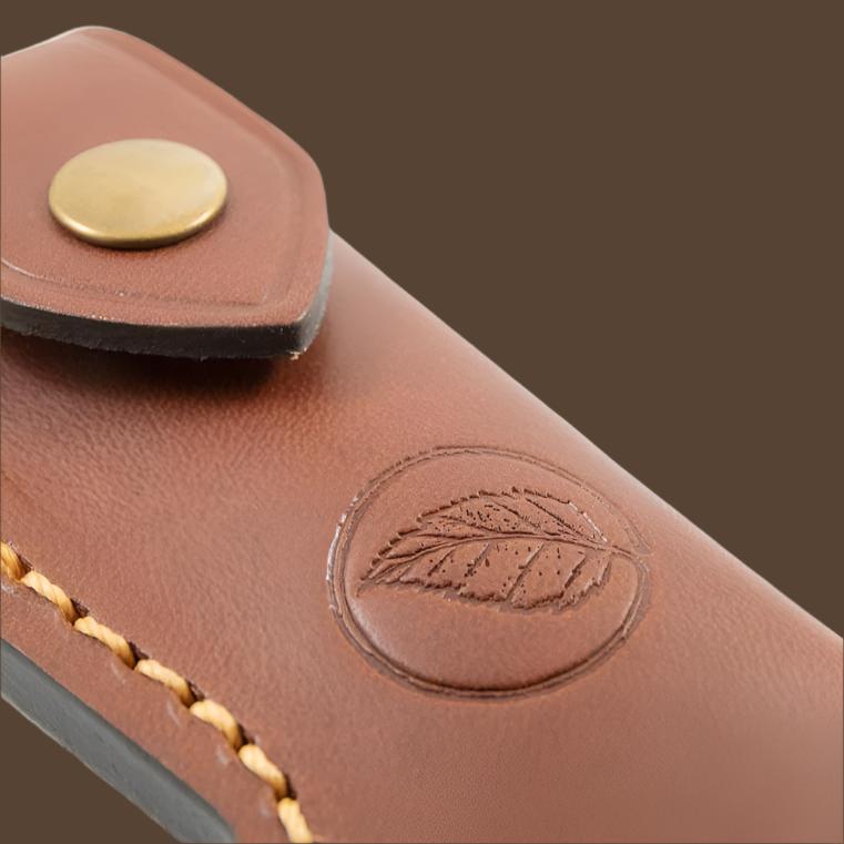 Close up of the distinctive  Casström leaf logo on the leather folding knife pouch