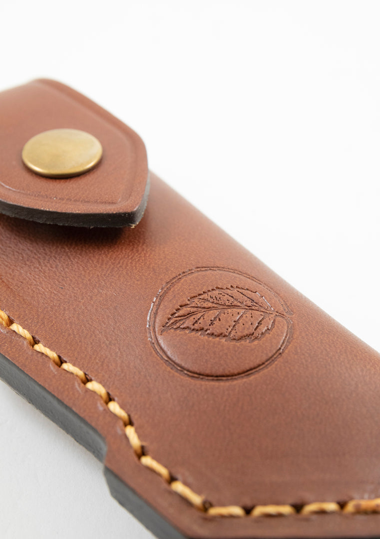 Close up of the distinctive  Casström leaf logo on the leather folding knife pouch