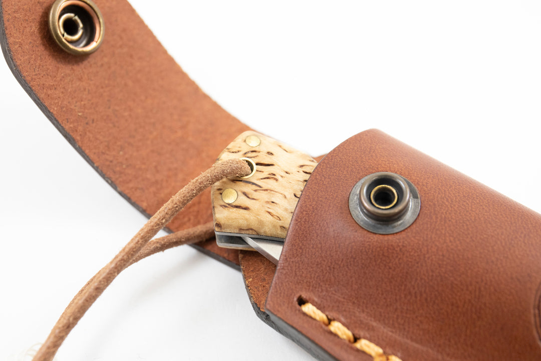 Press stud fastener for easy access on the Casström leather folding knife pouch.