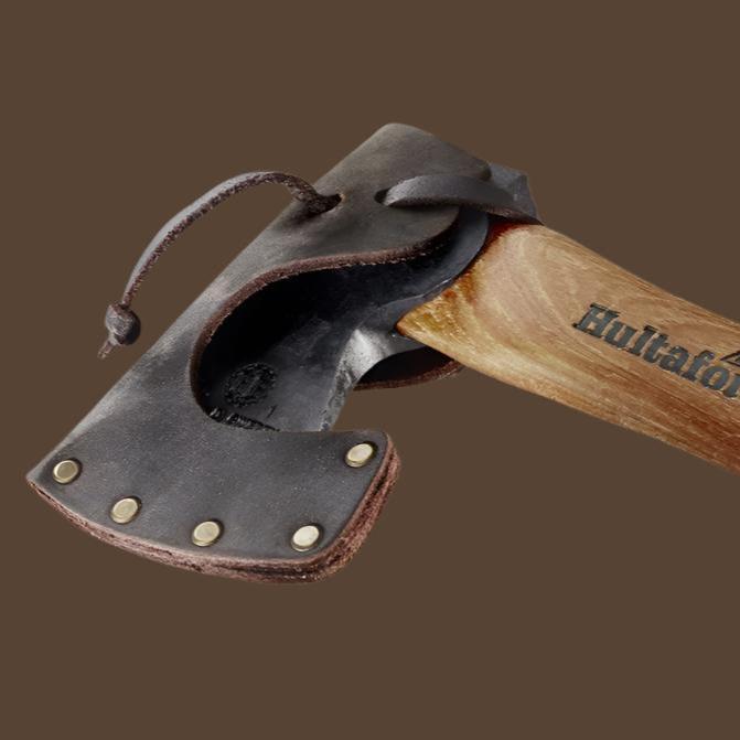 Close up of the axe head of a Hultafors mini hatchet in a leather sheath