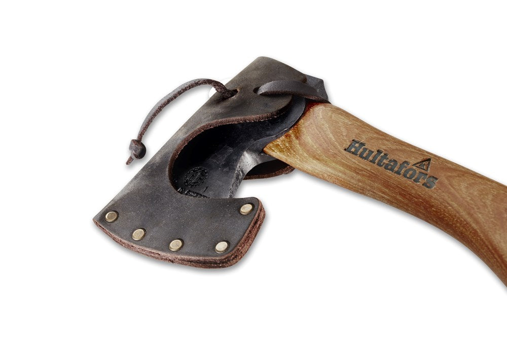 Close up of the axe head of a Hultafors mini hatchet in a leather sheath