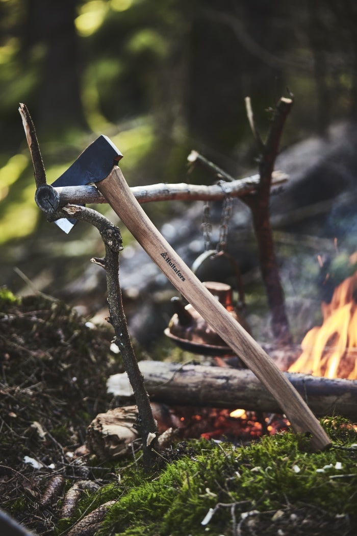 Lifestyle image of Hultafors Forest Axe next to a campfire